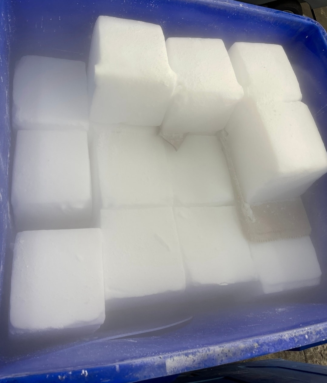 Dry ice blocks in a blue container — E-Z Dry Ice Company Philadelphia